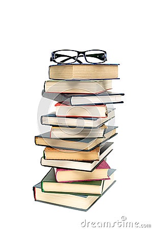 Glasses lying on a pile of books. white background - vertical ph Stock Photo