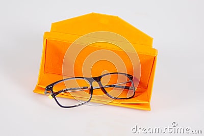 Glasses optical medical new in open orange case pyramid on a grey background table Stock Photo