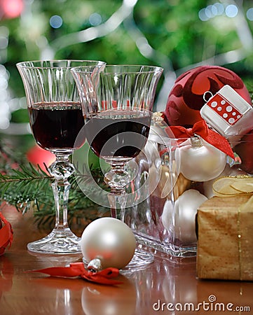 Glasses of red wine in front of Christmas tree Stock Photo