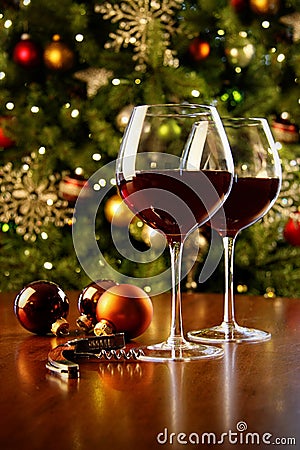 Glasses of red wine on table with Christmas tree Stock Photo