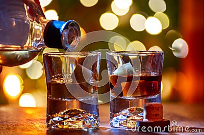 Glasses of scotch whisky served in bar in Edinburgh, Scotland, UK and pasry lights on background Stock Photo