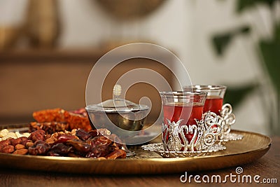 Glasses with tasty Turkish tea and oriental sweets on wooden table indoors, space for text Stock Photo
