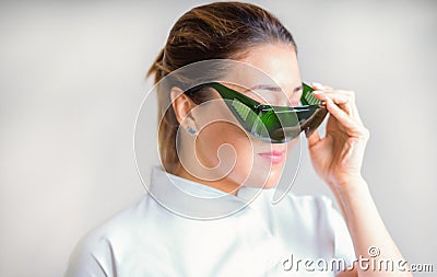 Glasses to protect your eyes from laser radiation in the hands of cosmetologist Stock Photo