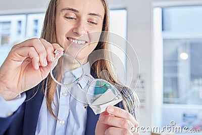 Glasses, vision and an optometrist woman cleaning lenses in a store to sell a product for fashion. Hands, eyewear and Stock Photo