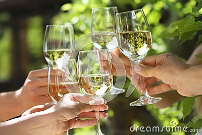 Glasses of white wine making a toast Stock Photo