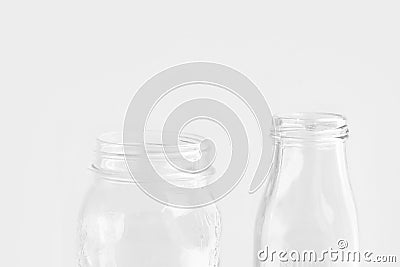 Glassware crystal bottle mason jar on white wall background. Reusable materials plastic-free alternatives zero waste Stock Photo