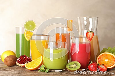 Glassware with different juices and fresh fruits Stock Photo