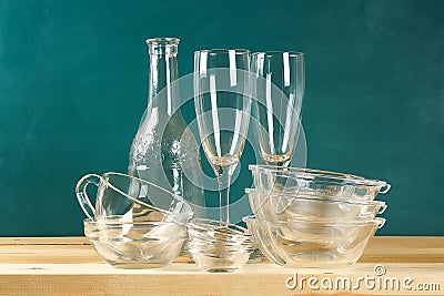Glassware. Glass plates, cups, bowls. Dishes on shelf. Kitchenware Stock Photo