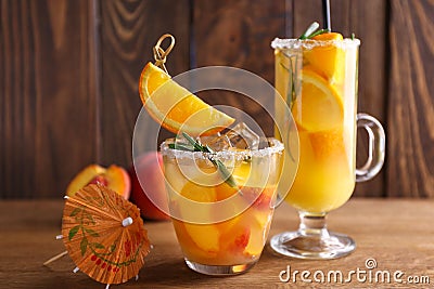 Glassware of tasty cold cocktails on wooden table Stock Photo