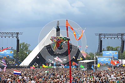 Glastonbury music festival Pyramid Stage crowds stormy sky Editorial Stock Photo
