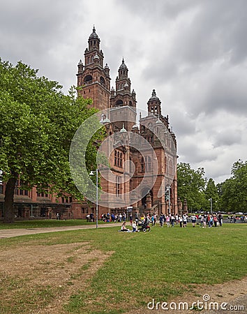Glaswegians enjoying the Summer heat in the grass outside the entrance of the Kelvingrove Museum. Editorial Stock Photo