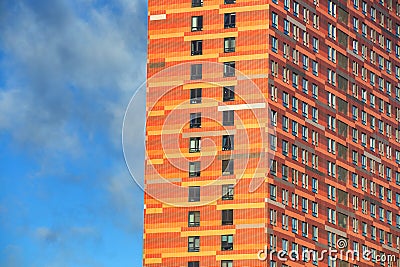 glazed facade of a high-rise building against a blue sky Stock Photo