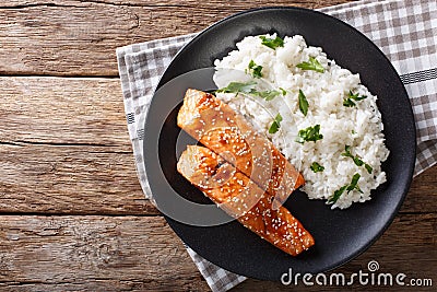 Glazed salmon fillet with rice garnish close-up. horizontal top Stock Photo