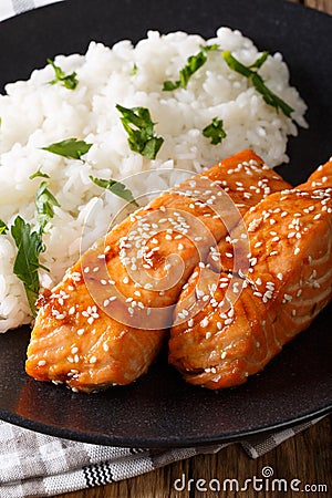 Glazed salmon fillet with rice garnish close-up. vertical Stock Photo