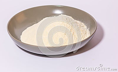 a glazed terracotta bowl containing wheat flour ready to be kneaded. Stock Photo