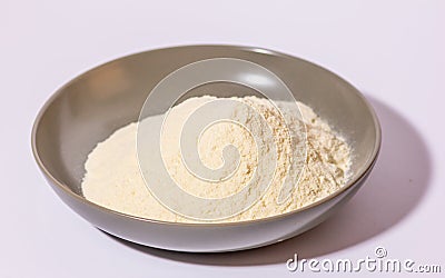 a glazed terracotta bowl containing wheat flour ready to be kneaded. Stock Photo