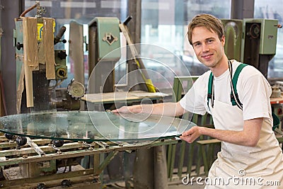 Glazier grinding a pieco of glass Stock Photo