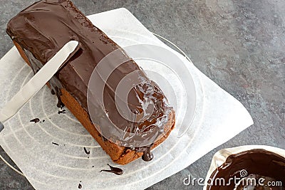 Glazing a Loaf Cake with Chocolate Couverture Stock Photo