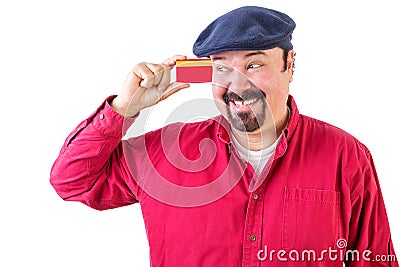 Gleeful man eyeing his credit card with a smile Stock Photo