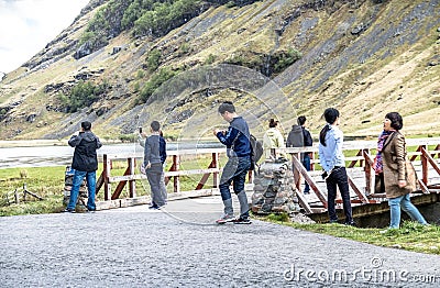 Glencoe Scotland - May 14 2017 : Asian tourist enjoying the landscape Editorial Stock Photo