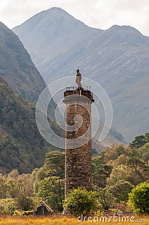 The Glenfinnan Monument, a tall column, topped by a statue of s kilted Highlander, in Glenfinnan, Scotland Editorial Stock Photo