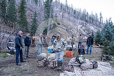 Group of hunters gather at a campsite after an elk hunting trip in the mountains Editorial Stock Photo