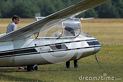 Glider plane standing on grass airport runway, at Pociunu airport, Lithuania Editorial Stock Photo