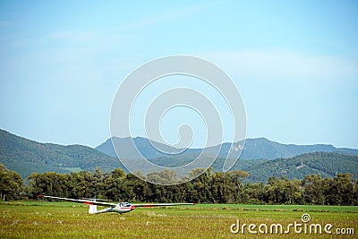 A glider or sailplane - aircraft landed on the ground. Stock Photo