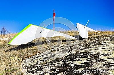 Gliders parked on mountain rock waiting appropriate wind for take off Stock Photo