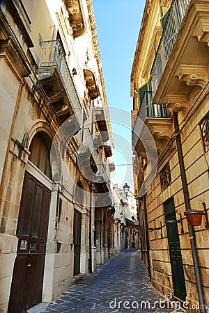 Glimpse of picturesque narrow alley of mediterranean destination Ortigia Syracuse Stock Photo