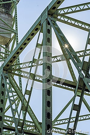 Glint of sunlight on the intertwining openwork trusses of the metal drawbridge Stock Photo