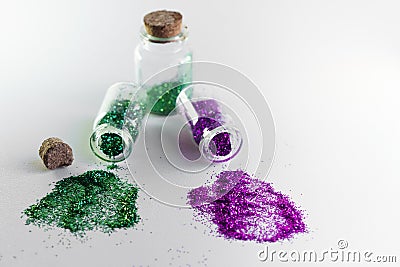 Glitter bottles spilled on a white background with copy space. Concept of glitter sales ban in Europe Stock Photo