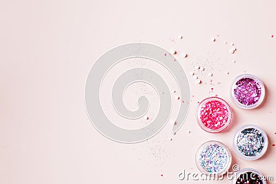 Glitter boxes for nail design on pink background. Festive manicure. Copy space. Stock Photo