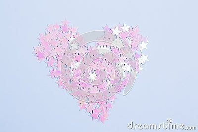 Glitter pink stars in a shape of heart on a light blue background. Love concept Stock Photo