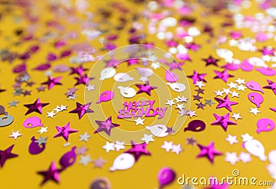 Glittering confetti on yellow background Stock Photo