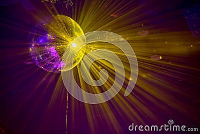 Glittering disco ball sphere background with light rays close up Stock Photo