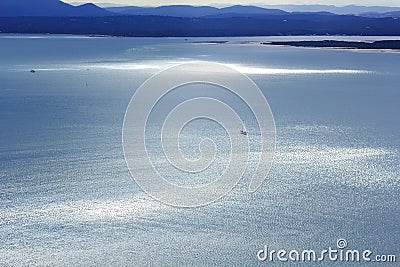 Glistening sea in coastal landscape by blue hour aerial view Stock Photo