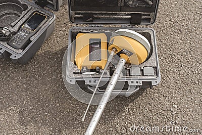 A Global Navigation Satellite System or GNSS Receiver in a hard case prior to being set up. Real-time kinematic or RTK geodetic Stock Photo