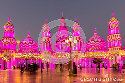 Global Village amusement park at night with pink illuminated arabic style towers and domes. Editorial Stock Photo