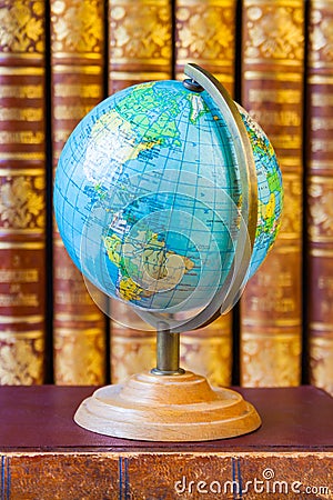 Globe on the background of pile of vintage books Stock Photo