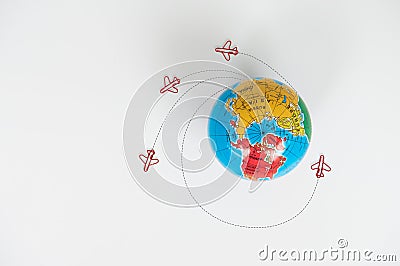 Globe model with air plane paper clip flying circle on the white background for transport and travel concept Stock Photo