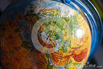 Globe with Russian letters with the focus on Europe close-up Stock Photo