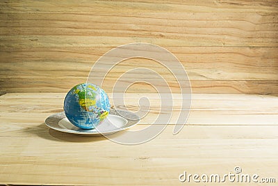 Globe toy placed on the plate. Stock Photo