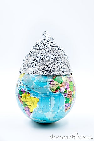 Globe wearing a tin foil hat, isolated on white background, concept conspiracy theory Stock Photo