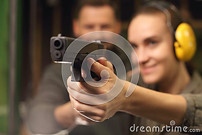 Glock, woman shoots at the shooting range Stock Photo