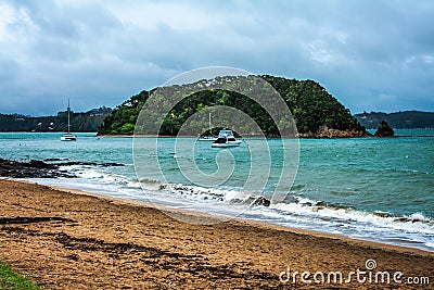 Gloomy dark cloudy sky over restless sea. Leasure boats popping in the waves not far from the shore Stock Photo