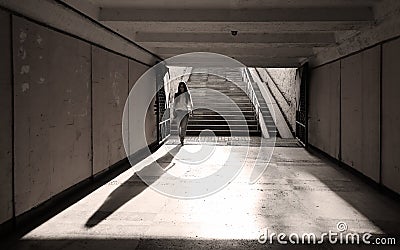 Gloomy long pedestrian underpass tunnel in dark colors Stock Photo