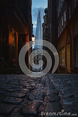 Gloomy view of Cobblestone Street with the Shard London in the Background Editorial Stock Photo