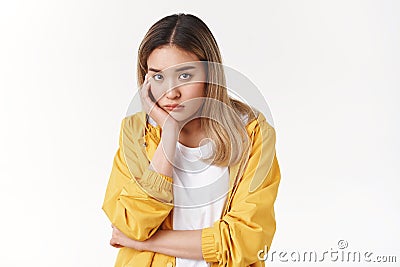 Gloomy young sad asian blond girl sighing upset stoop look from under forehead lonely unhappy lean palm bored feel Stock Photo