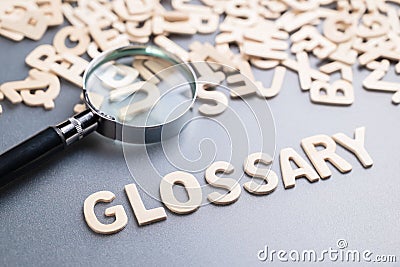 Glossary topic with magnifying glass Stock Photo